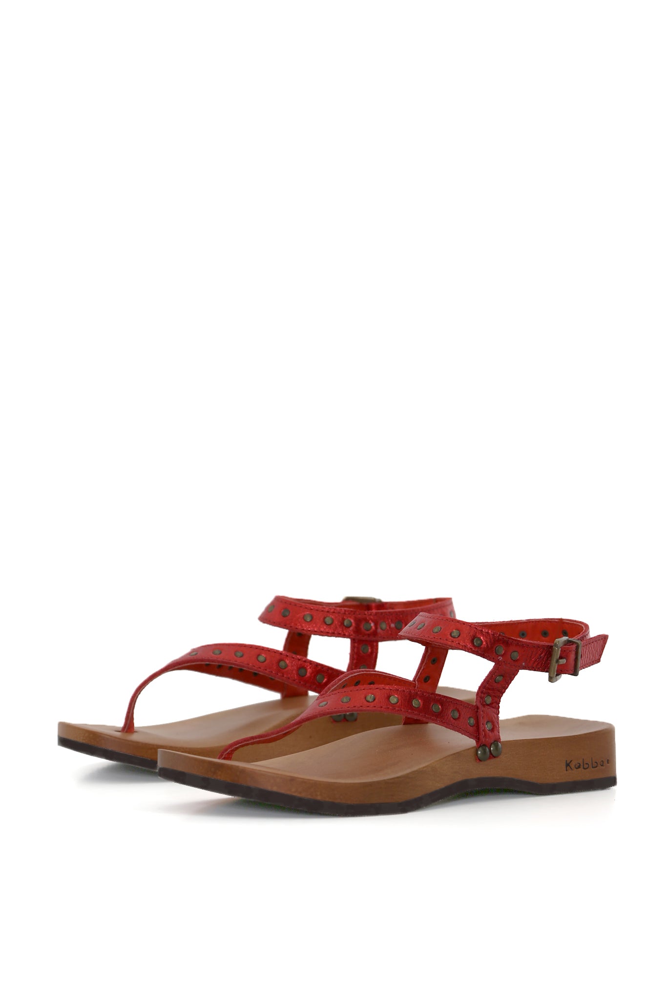 sandalia DK Dafne roja, cuero floater con tachas, tobillera ajustable, base tepa 3,5 cm, fondo blanco. zapatos anatómicos