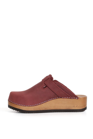 Zueco Kebba tradicional en cuero West guinda, diseño rústico y opaco. Planta anatómica de madera nativa con 5 cm de altura. Imagen trasera sobre fondo blanco. Piezas únicas en colecciones limitadas. Hecho a mano en Villarrica. Kebba: tradición y herencia en tus manos