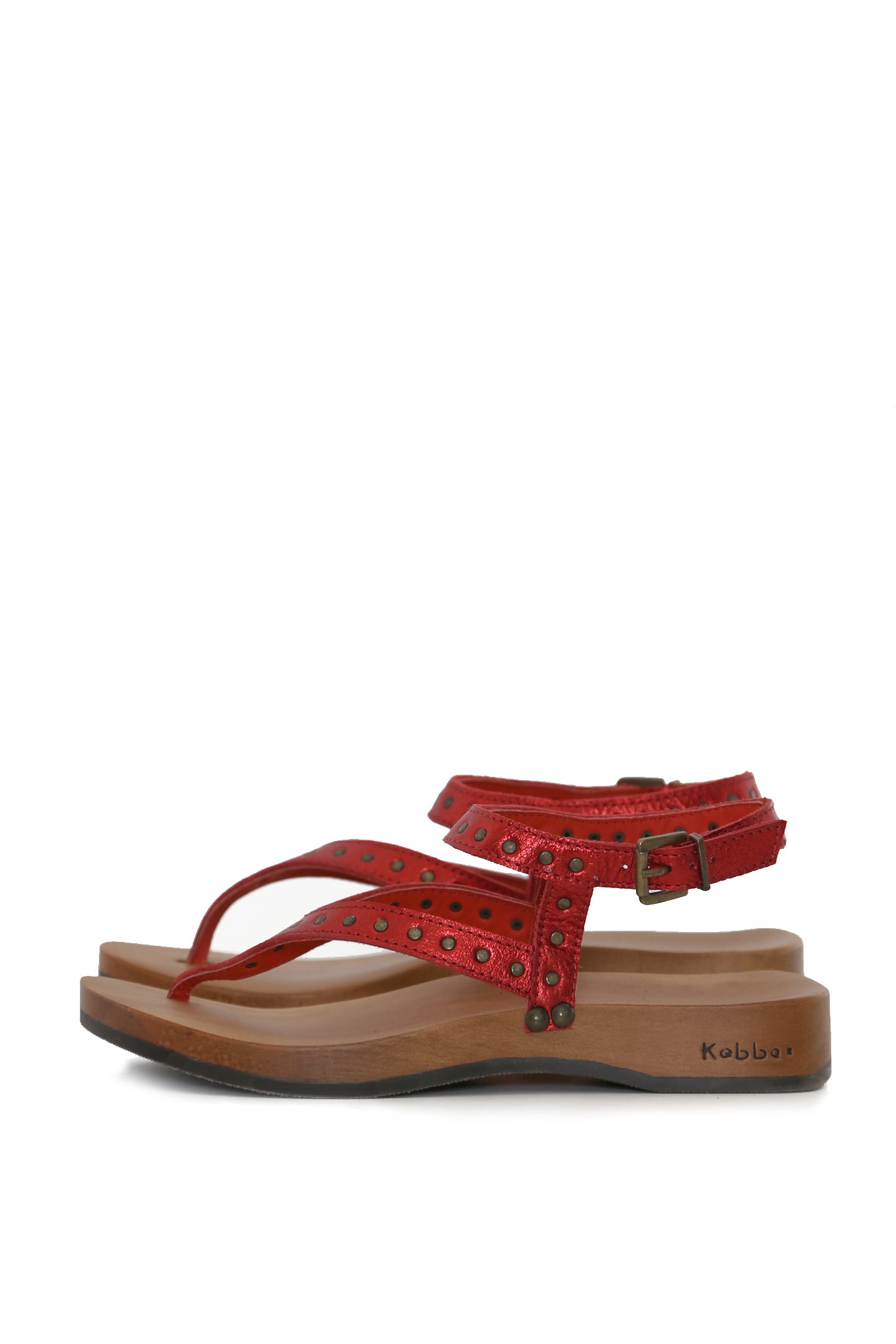 sandalia roja de dedo con tachas y hebilla, vista lateral; planta DK anatómica 3,5 cm en madera tepa. zapatos anatómicos