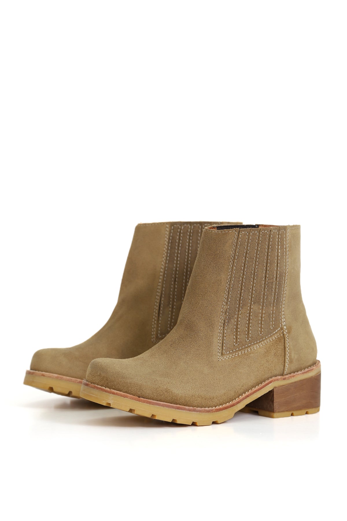 Simonita Sancho Geolux Zizal, botín de cuero con tono verdoso. Imagen en ángulo tres cuartos sobre fondo blanco. Elásticos laterales, taco de 5 cm en planta Simonita y plantilla de cuero. Hecho a mano en Villarrica. Kebba: tradición y herencia en tus manos